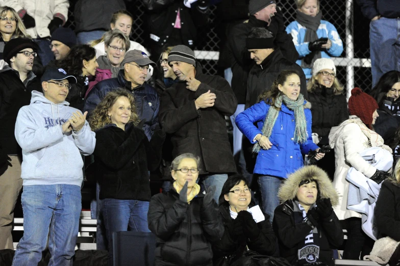 a crowd of people in the stands of a baseball stadium