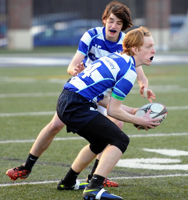 two males on a field are playing with each other