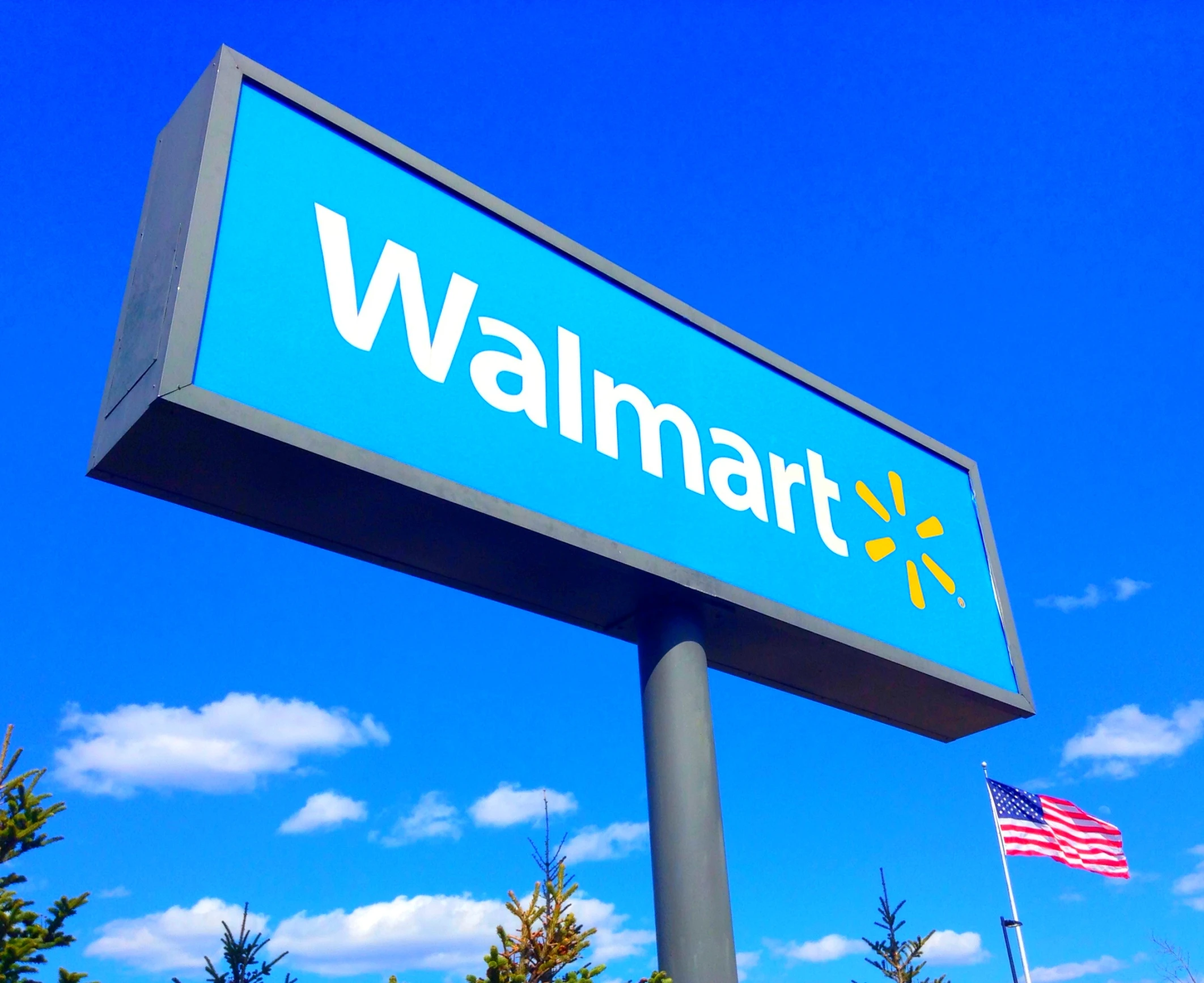 the sign for walmart outside on a clear day