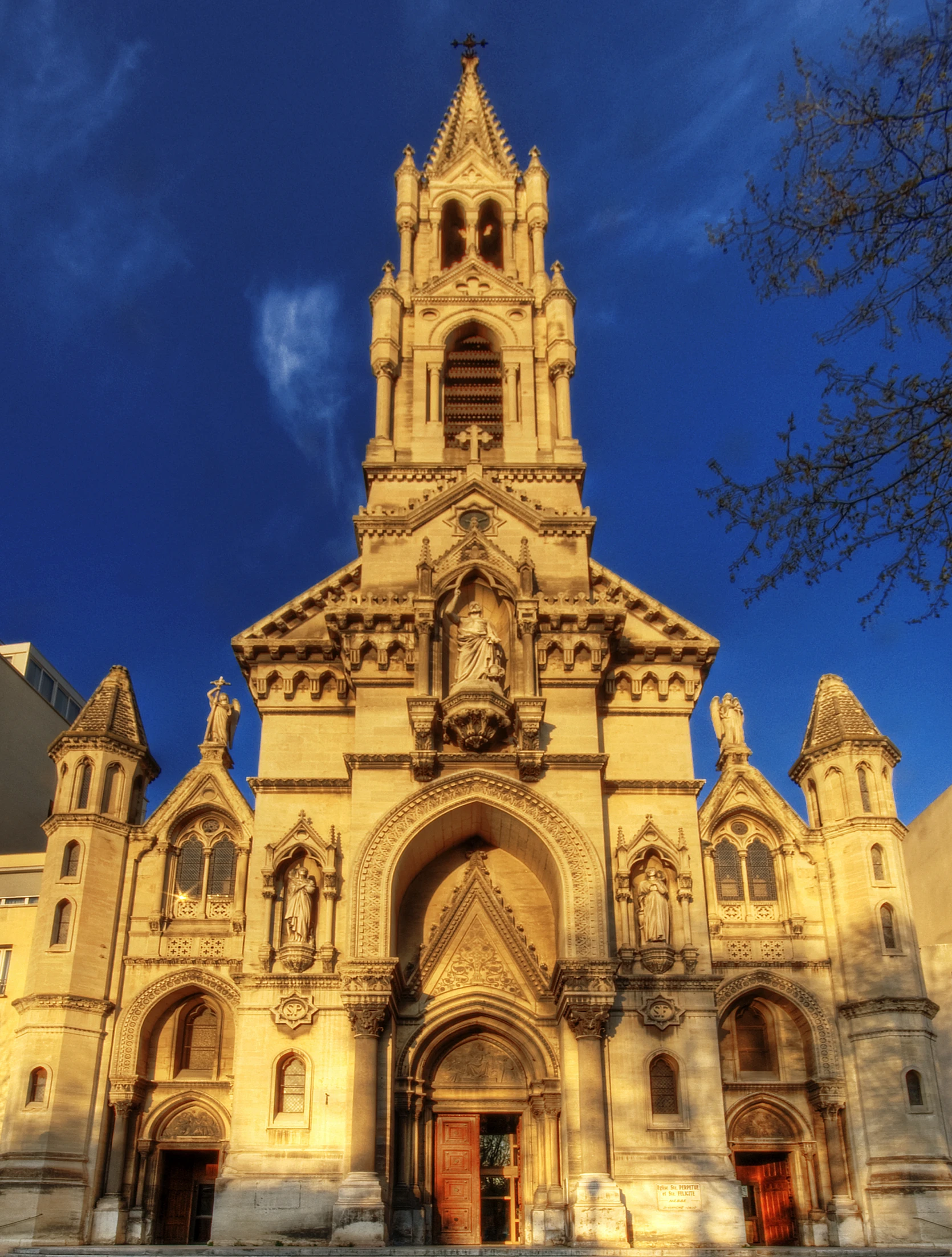 an old gothic looking building with clock on it's front