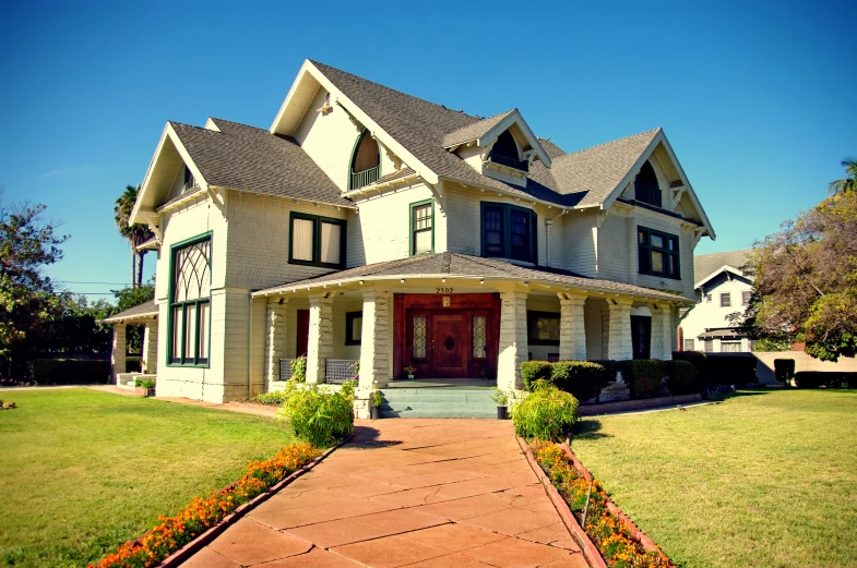 a large two story home on the corner of a street