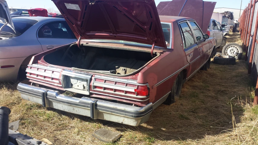 a red car with the hood open sitting parked