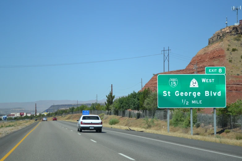 highway signs on the road in a city area