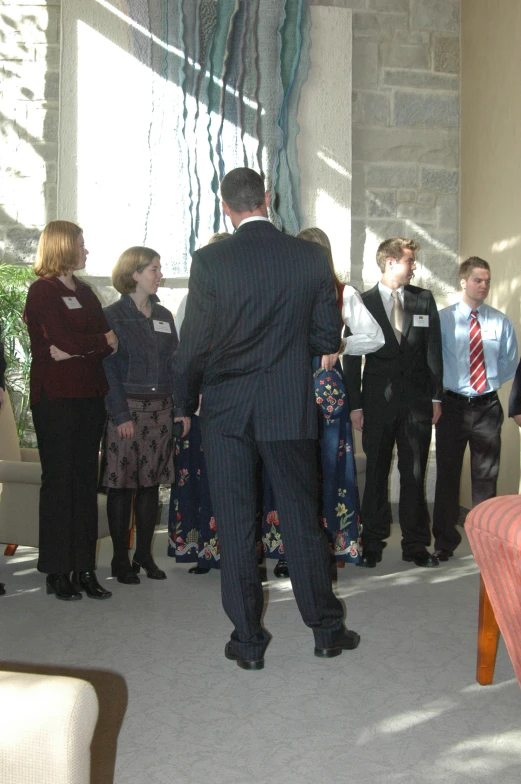 people stand with arms around each other near the couch