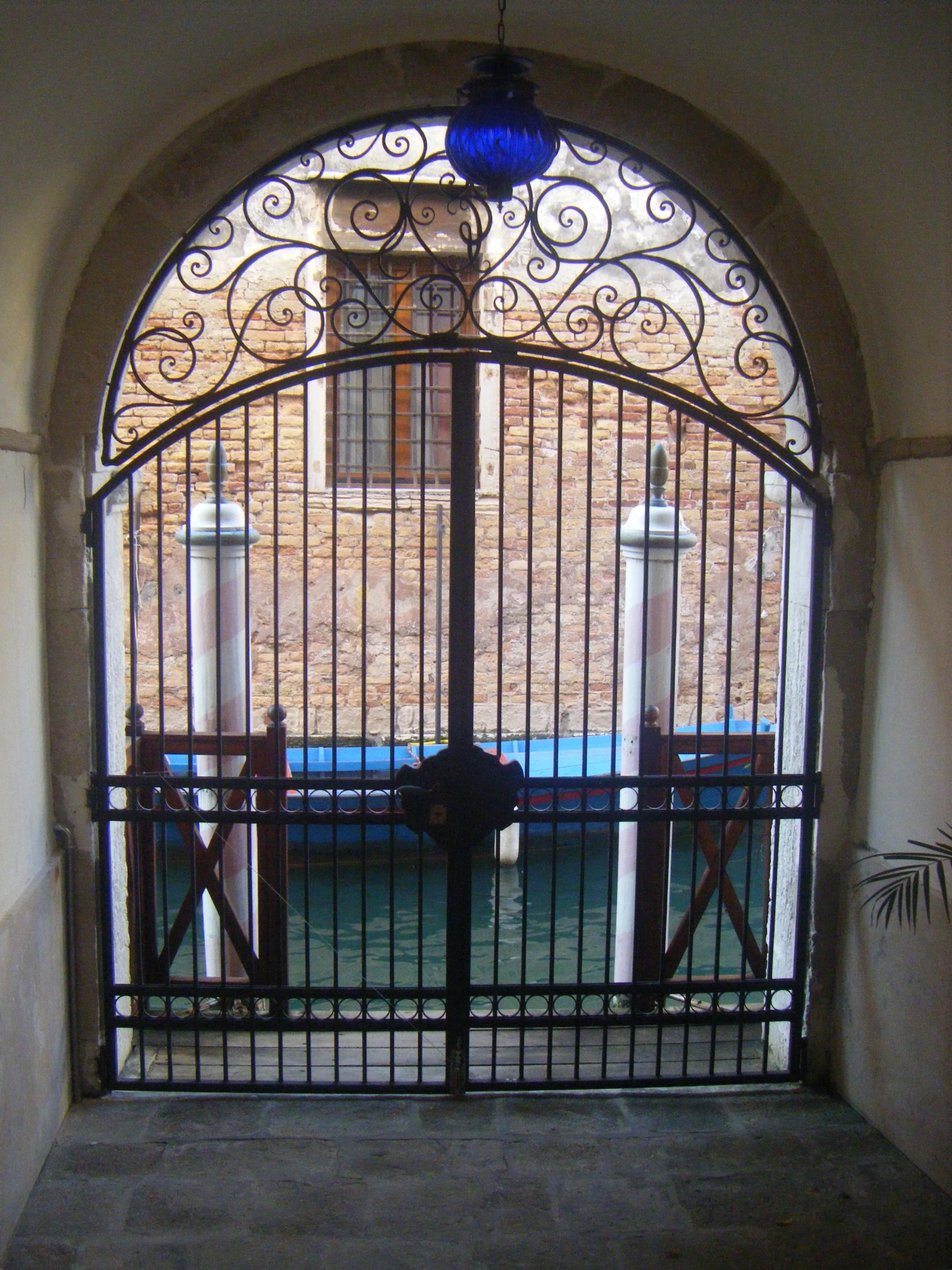 a gate with iron designs and gates leading to a courtyard