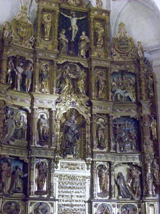 a gold ornate church with carvings on the side