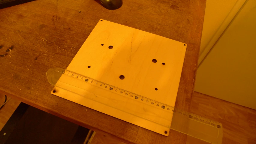 a wood frame with tape measure and a measuring tape on a wooden table