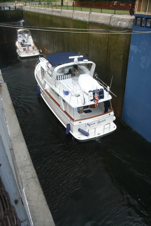 two boats parked on the side of a wall next to a road