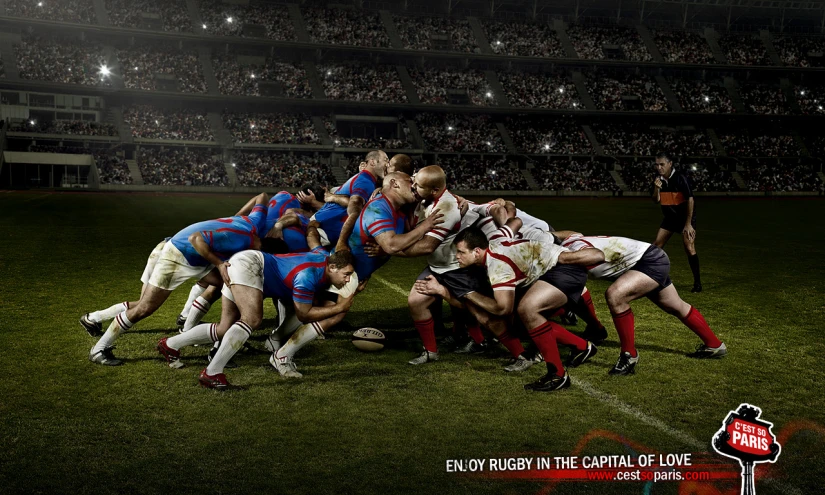 a group of men in red and blue uniforms are competing on the soccer field