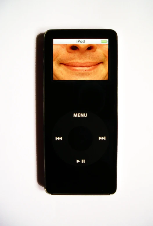 a close up of a remote control with a smile on it