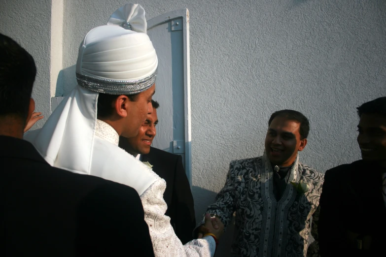 man dressed in all white at a wedding