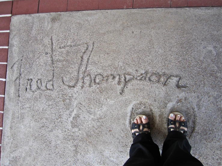 someone's feet and feet on a sidewalk saying hello morning