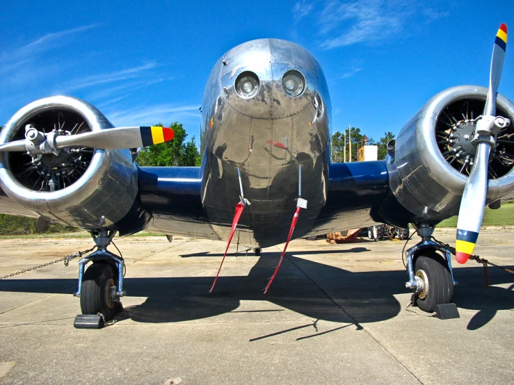 a plane on the tarmac with its propellers on