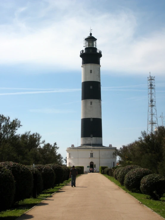 a tall lighthouse sitting over a small pathway