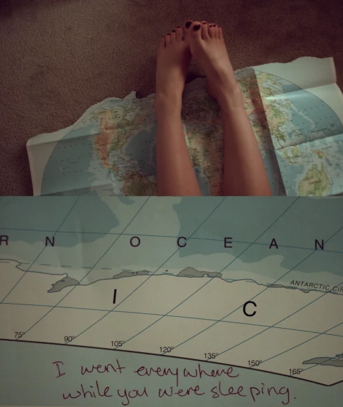 a person's feet are shown on the map, next to paper with a drawing of a woman