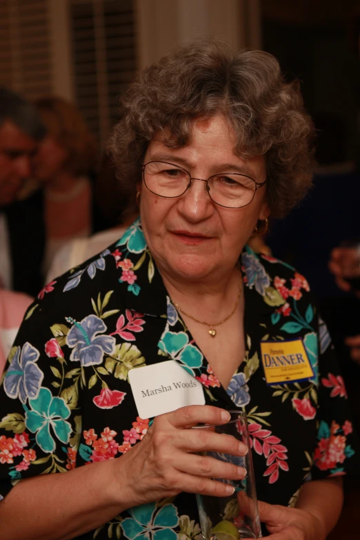 a woman is holding a card in her hand