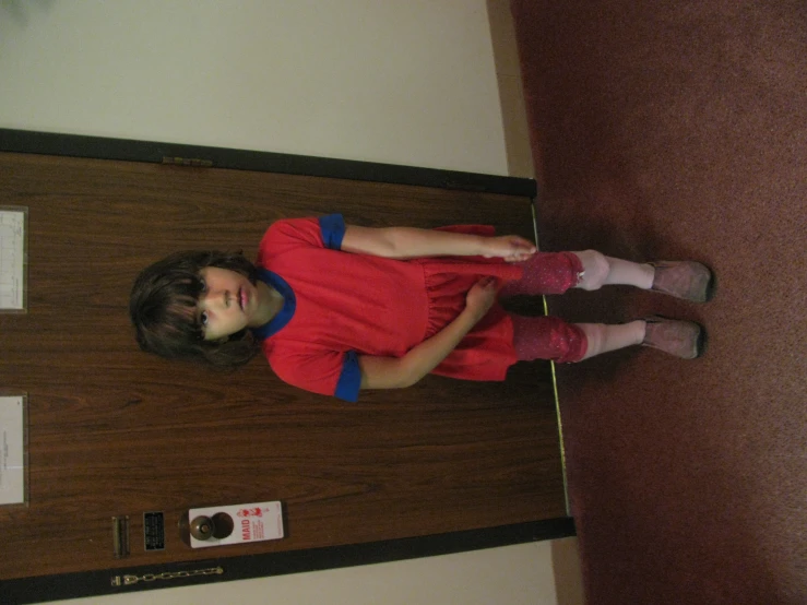 a young child standing next to a doorway