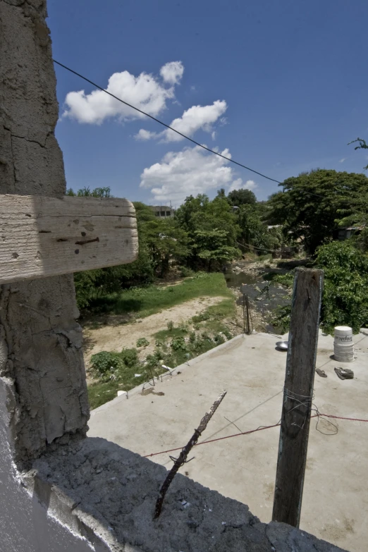 a dirt path near a building and a fence