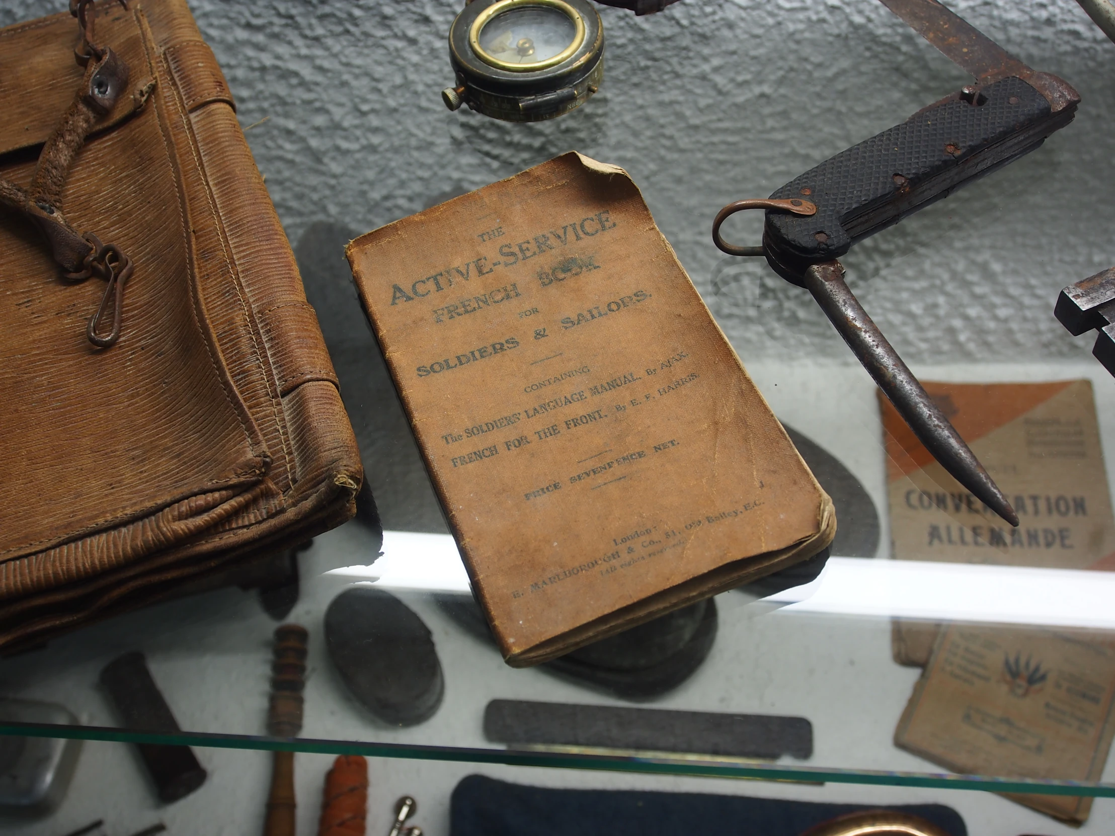 old fashioned items including a book, a watch, and scissors are on display