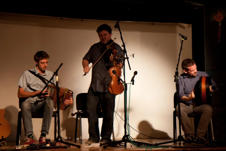 a group of musicians performing on a stage