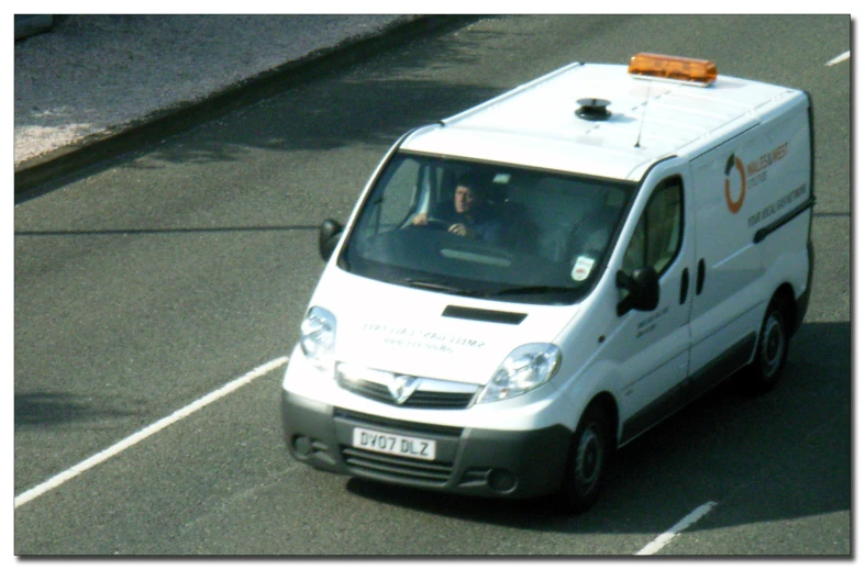 an image of a man driving a mini van