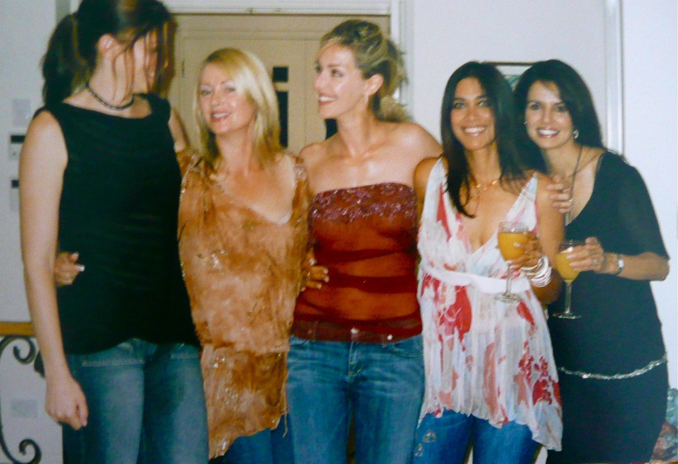 a group of women in fancy outfits and posing for the camera