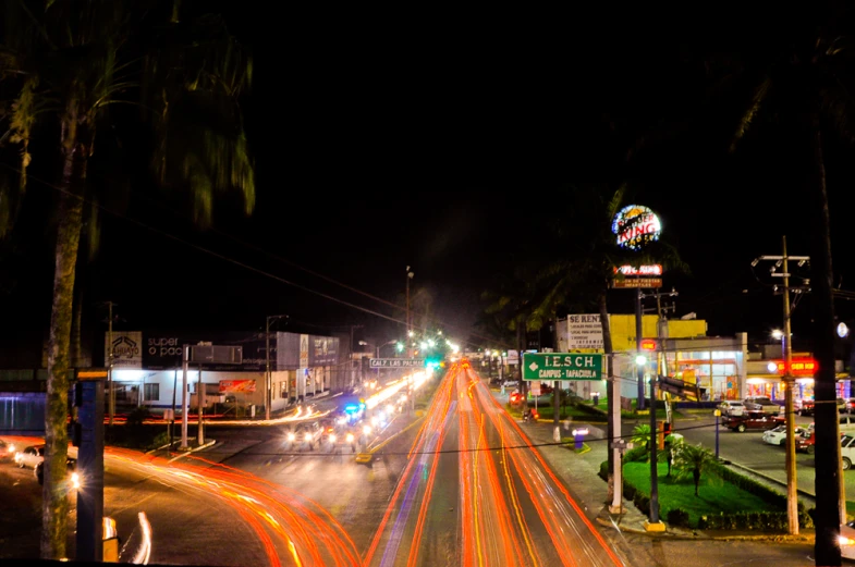 a street is shown with cars going down it