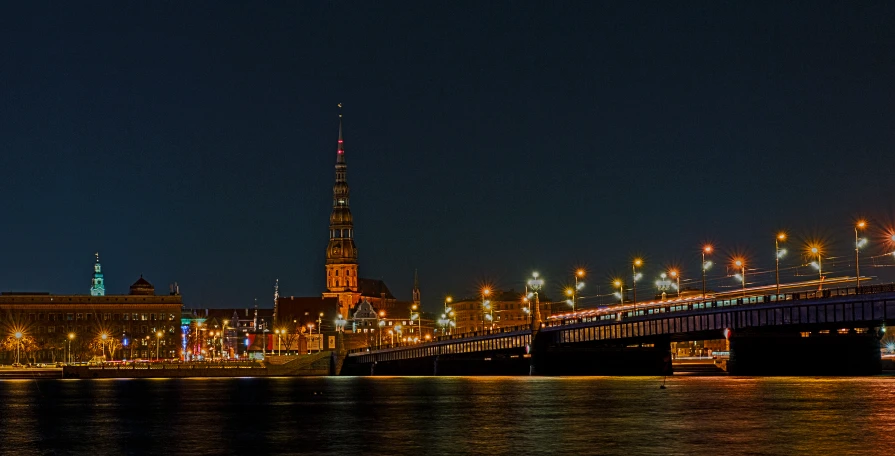 an illuminated city with a large bridge that spans it