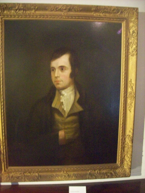 an older portrait painting in a frame on the wall