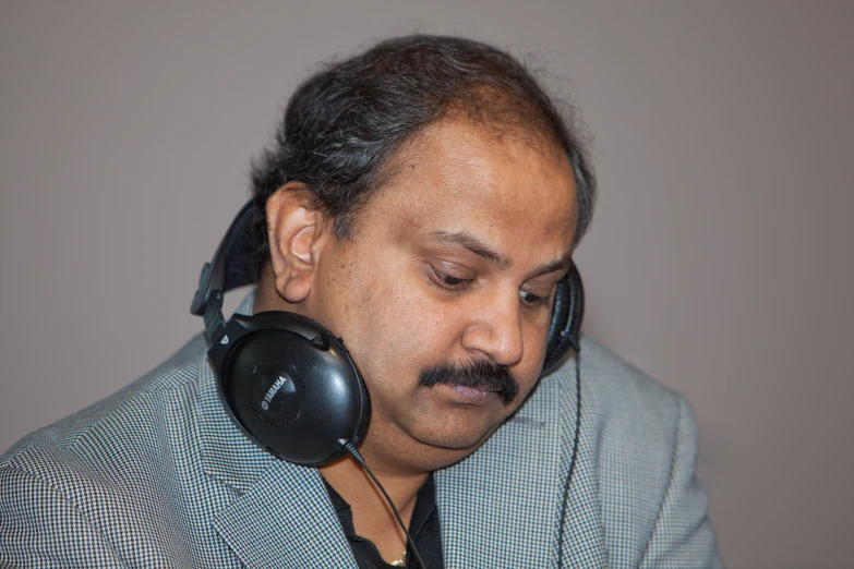 man with two headset's and ear phones