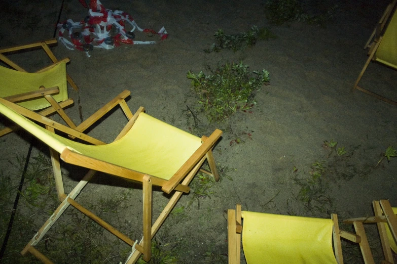 there are many chairs outside with a woman sitting in the chair