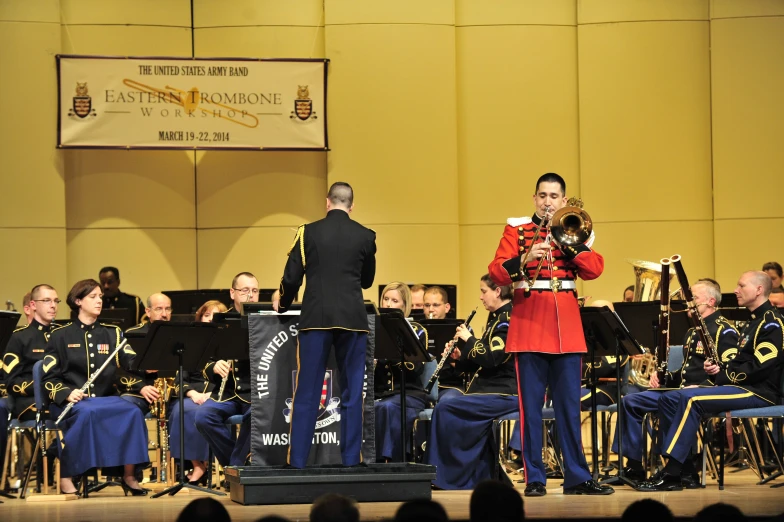 men in uniform with band standing on stage
