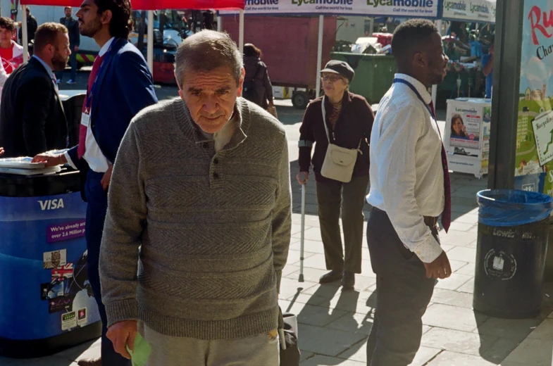 a man walking past a crowd of people