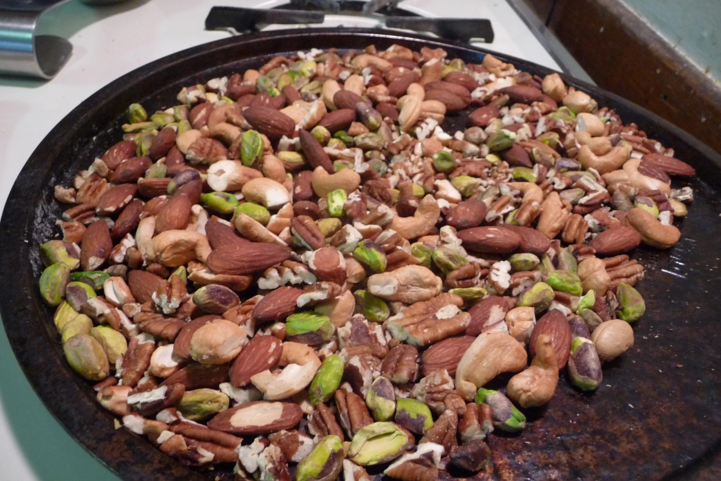 a pan filled with different types of nuts on top of a stove