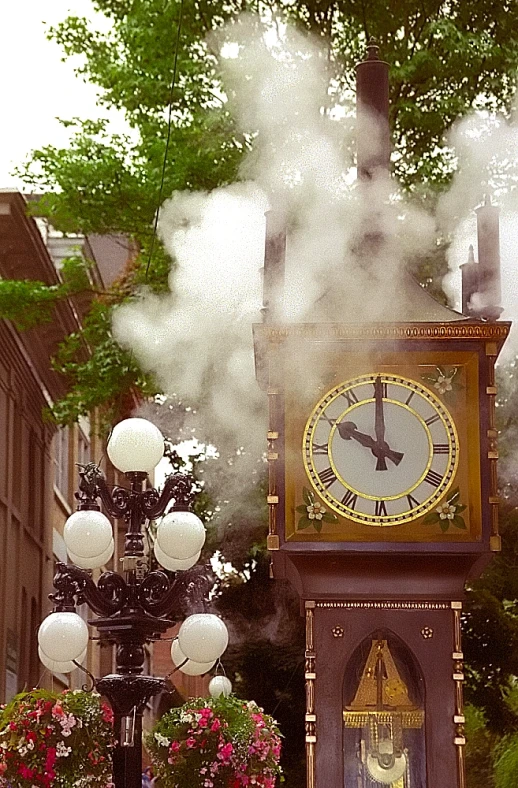 a steam clock tower on the side of a street