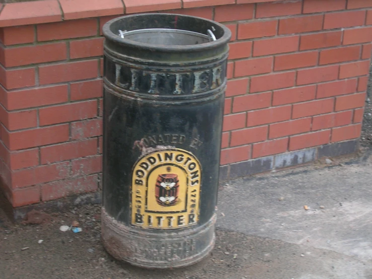 a big trash can by the side of a building
