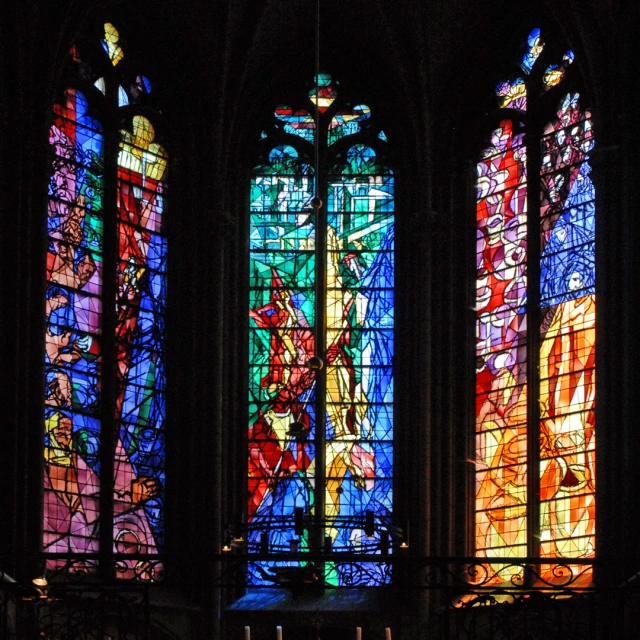 several windows in the inside of a church