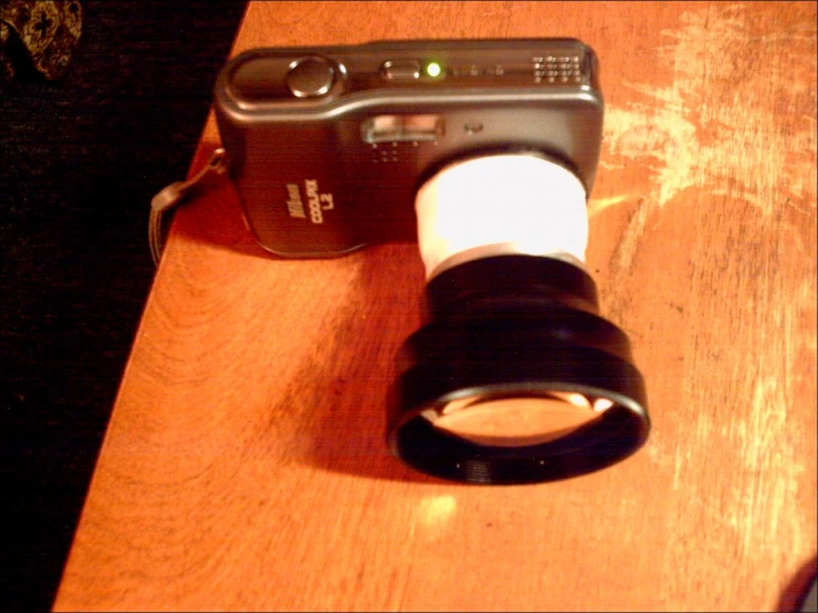 a camera sits on top of a wooden table