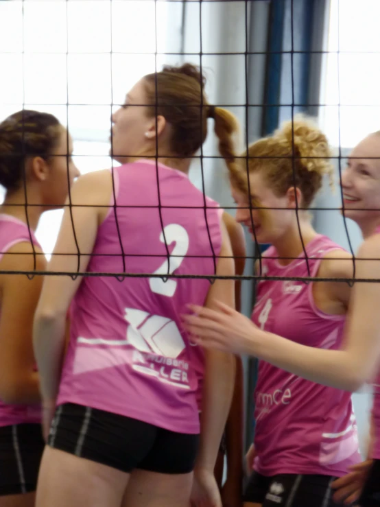 young female volleyball players talking to each other