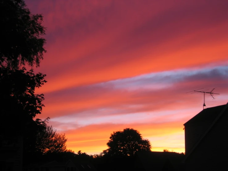 an image of the sunset behind a house