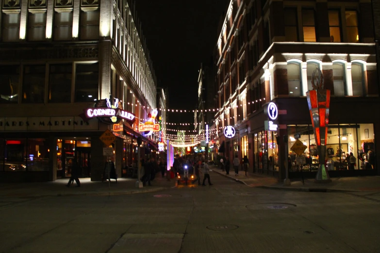 an empty street is lit up at night