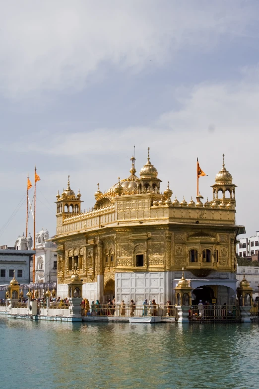 a very large beautiful golden building near the water