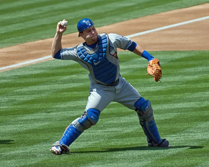 a man wearing catchers mitts in a baseball field