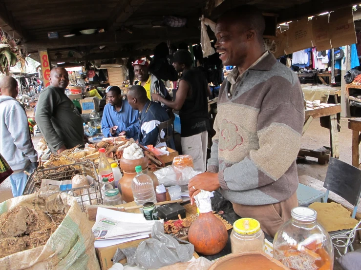 a man stands in front of a table filled with different items