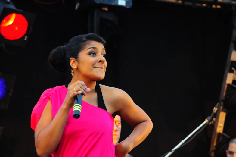 a woman holding a microphone on stage at an event