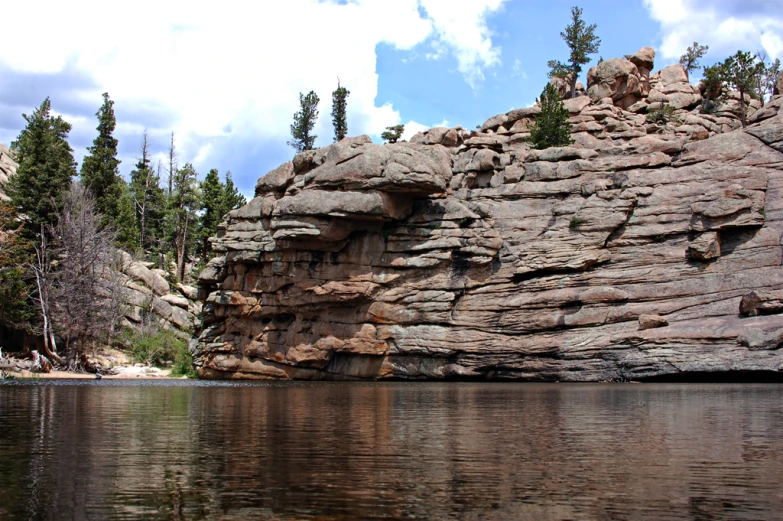 the lake is near a very large rock formation