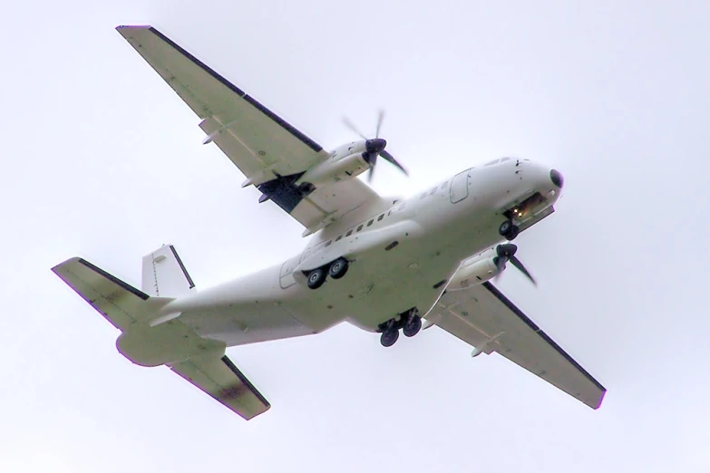 an airplane is flying through the sky with propellers