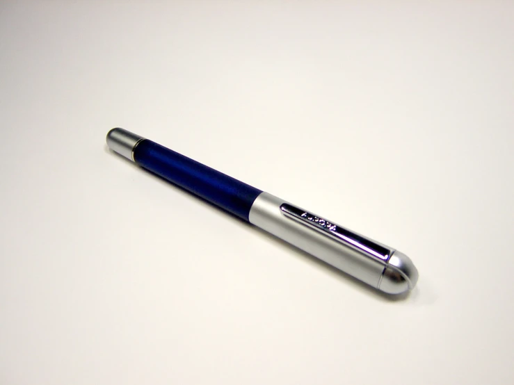 a pen on a white surface with it's cap missing