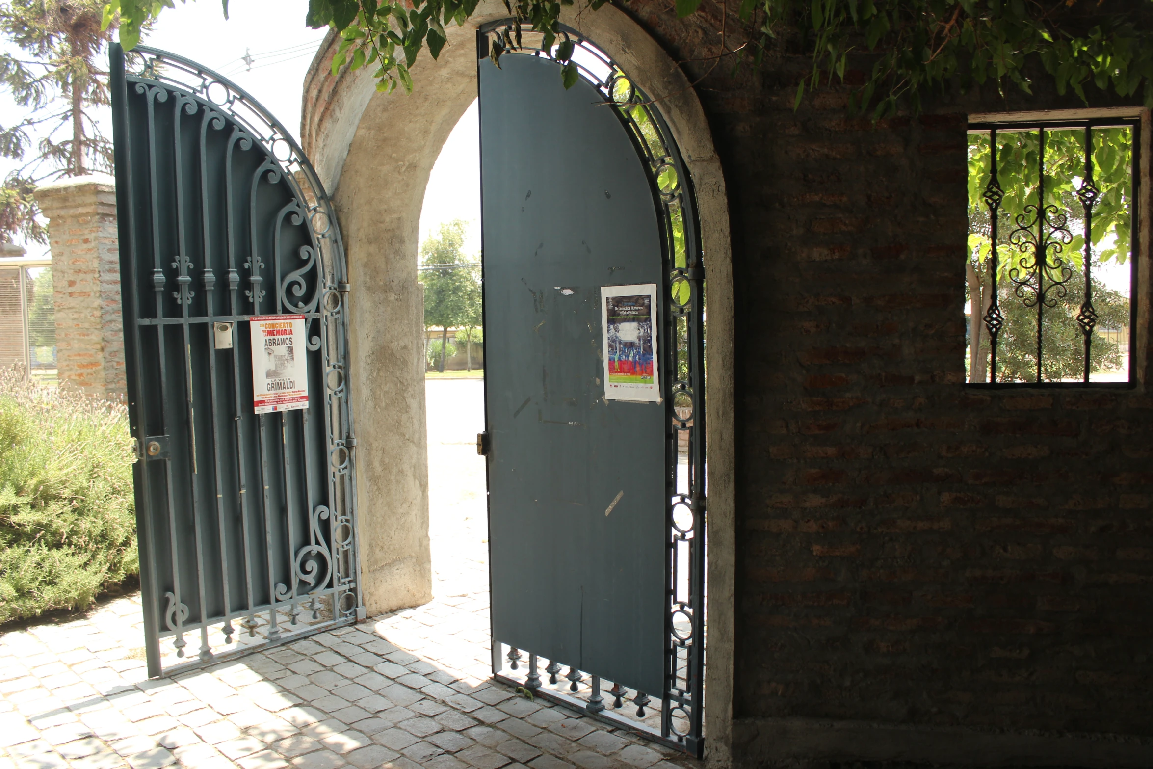 an iron gated entrance to a stone building