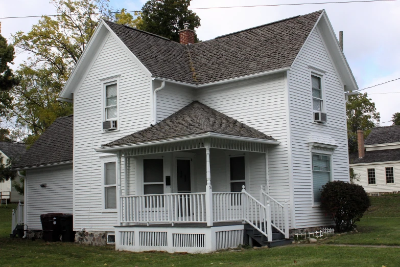 an old victorian white wooden house